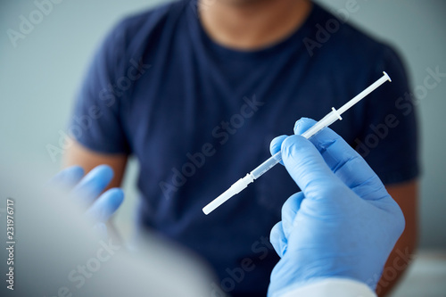 Close up of doctor holding a needle photo