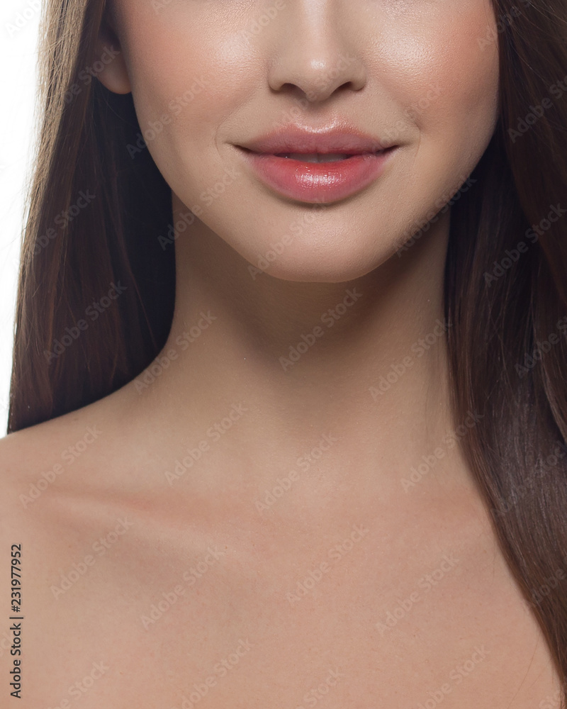 Obraz premium Cosmetics, makeup and trends. Bright lip gloss and lipstick on lips. Natural lip makeup. Beautiful part of female face. Perfect clean skin in red light