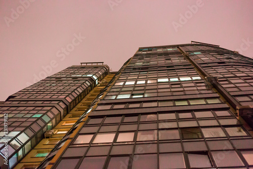 Modern office or residential building in the evening. Viewe from grownd to sky photo