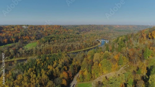 Bridge over the river, Autumn Forest Sigulda city nature, Gauya, 4K drone flight, bridge car drive from above photo