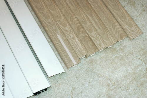Plinths of various colors are on the carpet. Samples to select the color and texture of the baseboard to the room