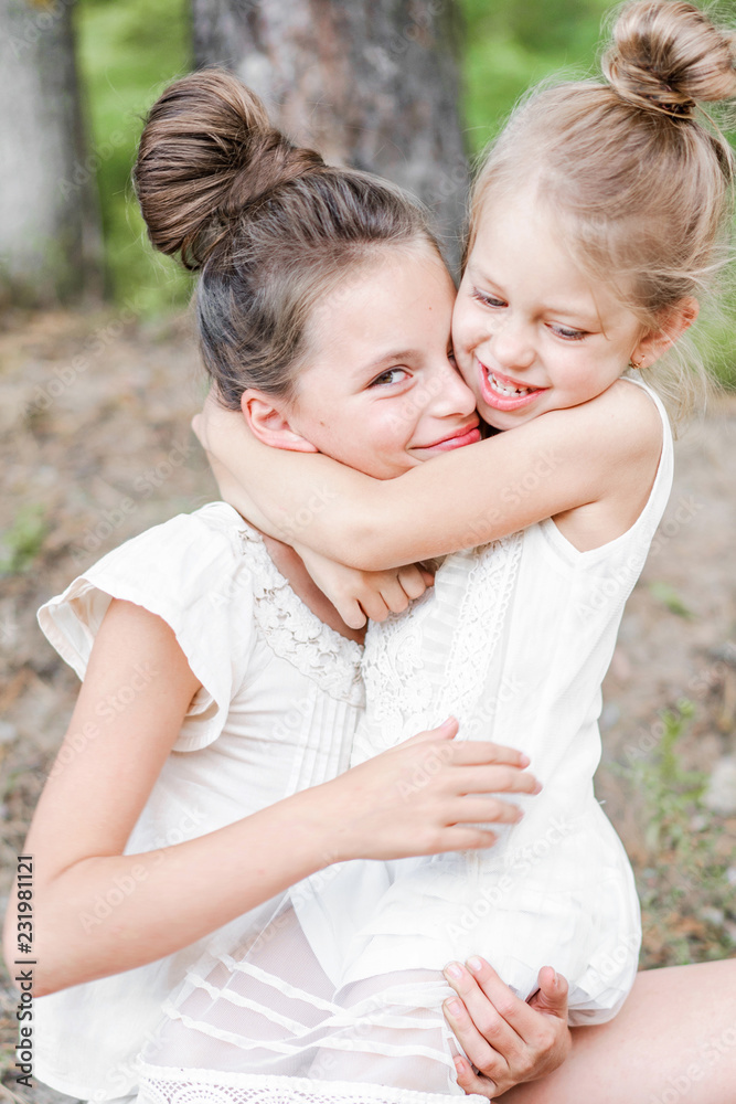 Fototapeta premium Portrait of two girls in the woods girlfriends