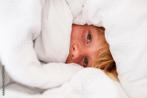 Portrait of a boy wrapped in a duvet photo