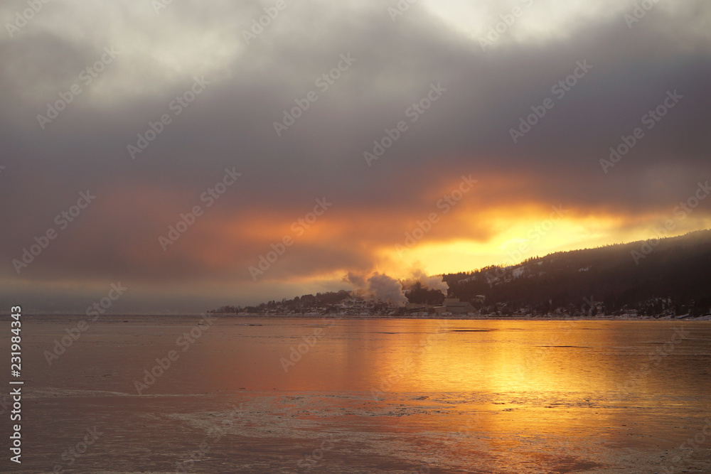 Sunrise and smoke from factory over Drammens fjord.