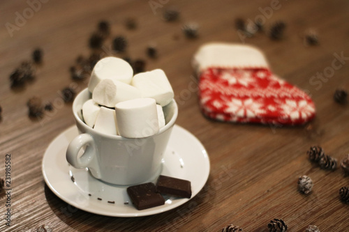 Making plans for christmas and new year eve in winter decorations and drinking hot choclate drink with marshmallows