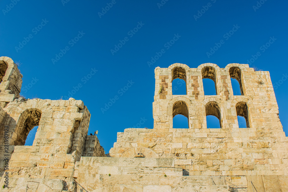 ancient yellow stone wall and arch ruins  on blue sky background with empty space for copy or text