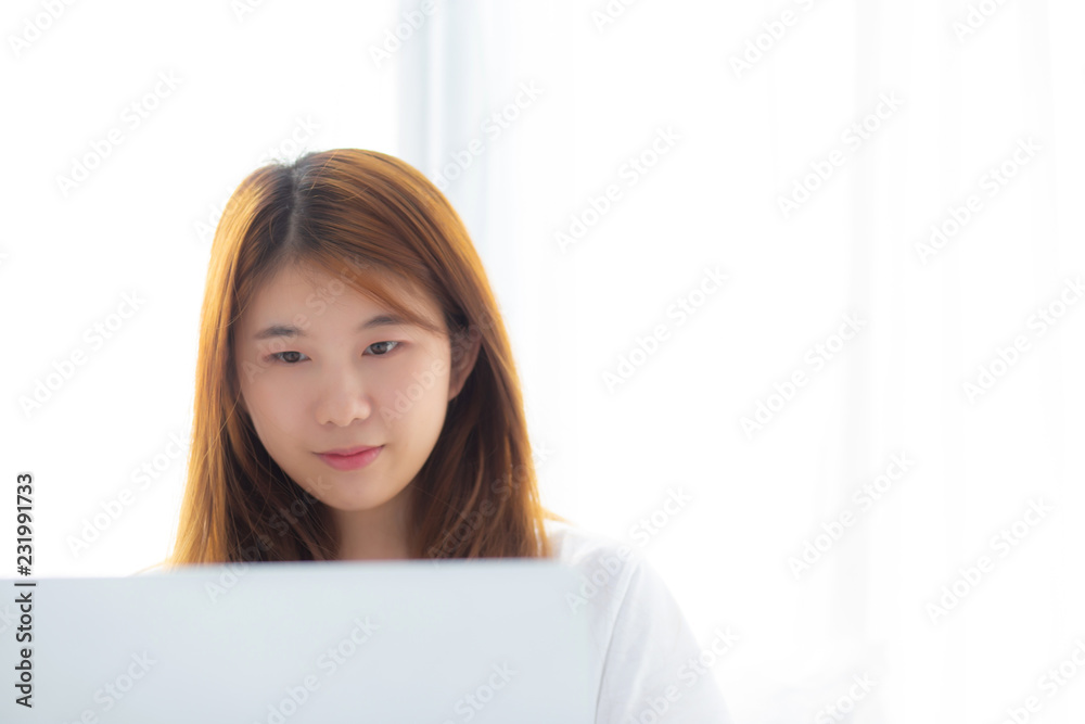 Portrait of beautiful asian young woman setting on bed using laptop computer at bedroom for leisure and relax, freelance with girl working notebook, communication and lifestyle concept. Portrait of beautiful asian young woman setting on bed using laptop computer at bedroom for leisure and relax, freelance with girl working notebook, communication and lifestyle concept.
