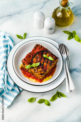 Fototapeta Naklejka Na Ścianę i Meble -  gluten free vegan lasagna. from grilled eggplant, green peas, lentils and vegetables. delicious healthy comfort food for the whole family for the holidays. italian parmigiana