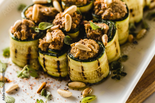 Carta da parati vegan appetizer of grilled zucchini and olive pate on a festive table