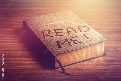 Holy Bible  book with read me letters on a wooden background