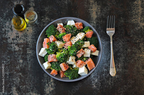 Healthy nutritious salad with broccoli, white cheese and salmon. Superfoods Fitness salad.