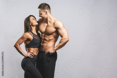 Athletic man and woman isolated over white background. Personal fitness instructor. Personal training. © denis_vermenko