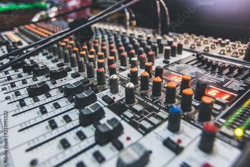 A mixing board up close on the knobs and levers