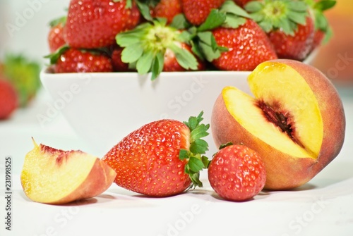  fresh cut peach and a bowl strawberry