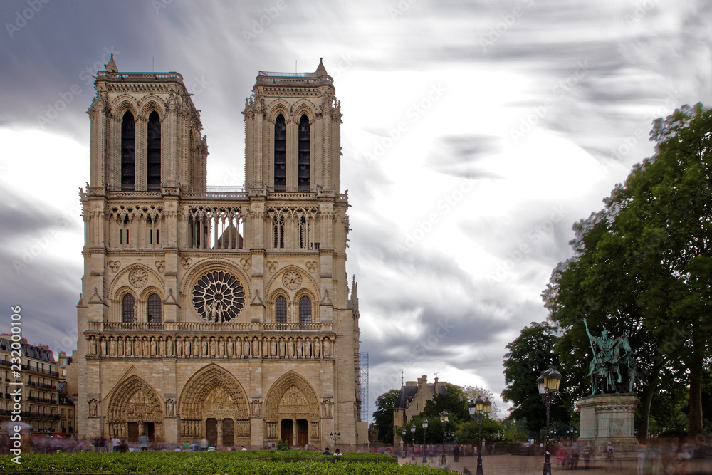 Paris, France - May 25, 2018: Notre Dame de Paris with unidentified people. The cathedral is among the largest and most well-known church buildings in the world and a landmark of Paris