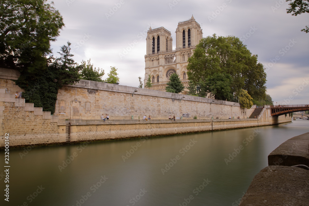 Paris, France - July 5, 2018: Notre Dame de Paris and Cite island captured from the opposite bank of Seine river