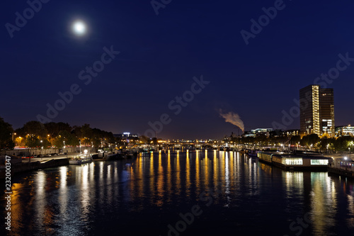 Paris, France - October 31, 2017: East of Paris, Bercy district, with reflection of lights into river Seine