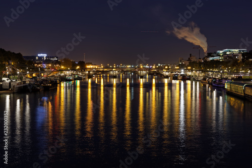 Paris, France - October 31, 2017: East of Paris, Bercy district, with reflection of lights into river Seine