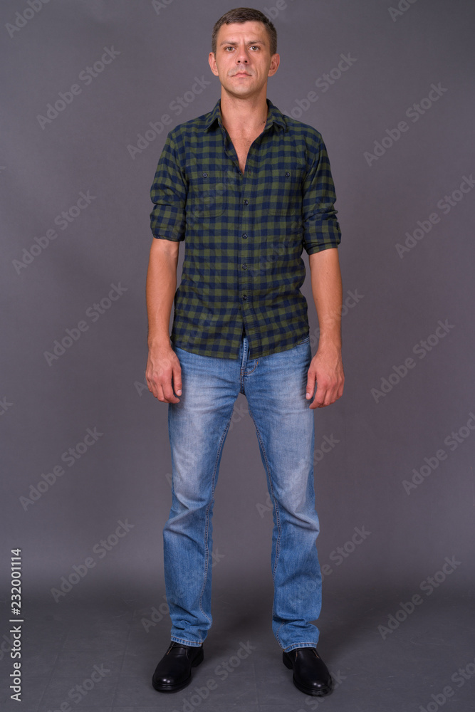Handsome man with short hair against gray background Handsome man with short hair against gray background