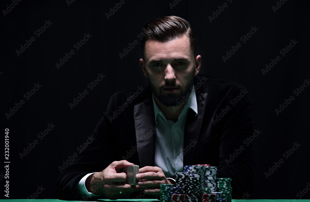A wealthy man playing poker with the excitement in a casino. A wealthy man playing poker with the excitement in a casino.