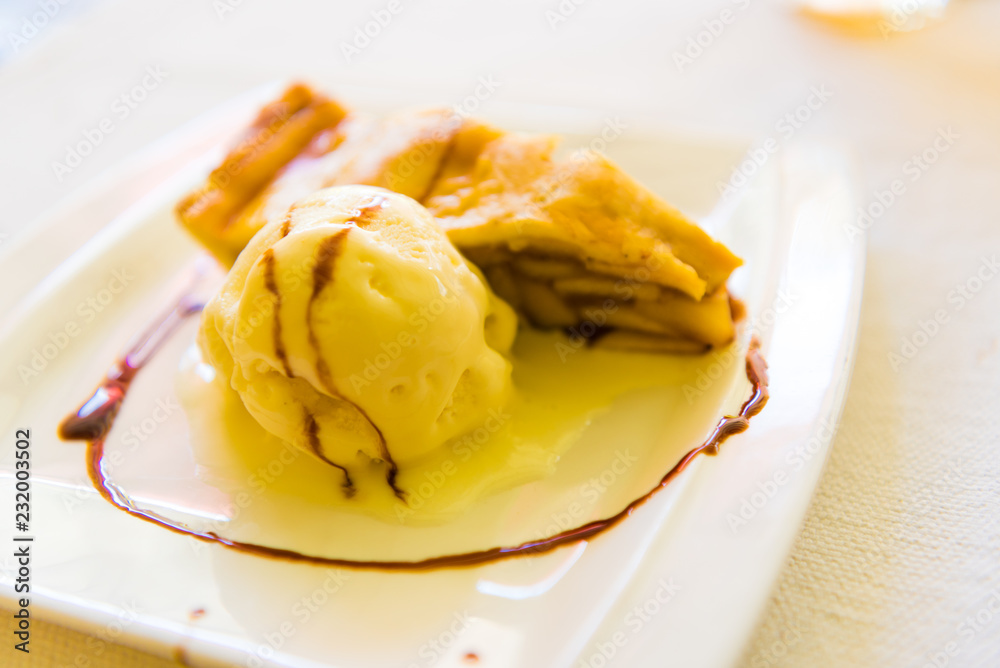 Piece of apple pie with ice cream next to it on plate, sweet dessert concept Piece of apple pie with ice cream next to it on plate, sweet dessert concept