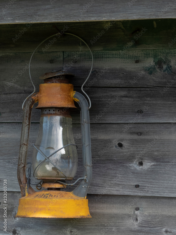 Old Lantern hanging on the side of barn