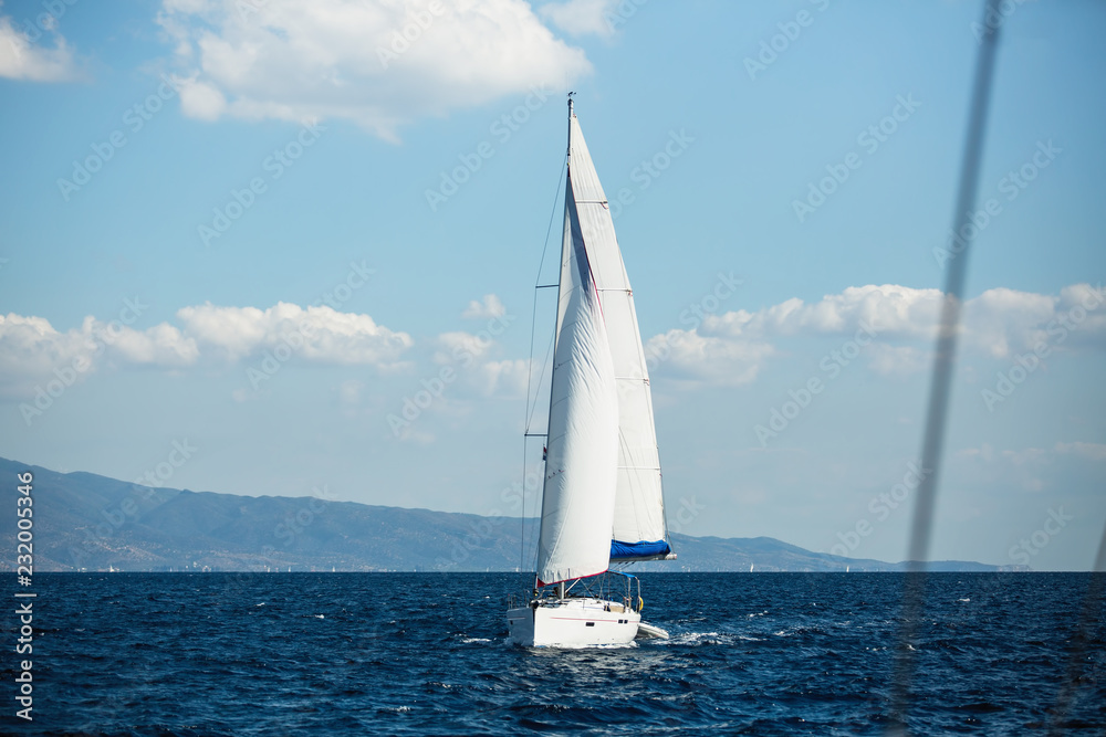 Fototapeta premium Sailboat participate in sailing yachts regatta among Greek island group in the Aegean Sea.