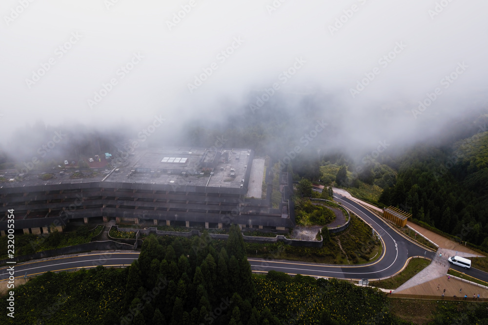 Top view of Abandoned hotel building in the fog on San Miguel island, Azores archipelago, Portugal.