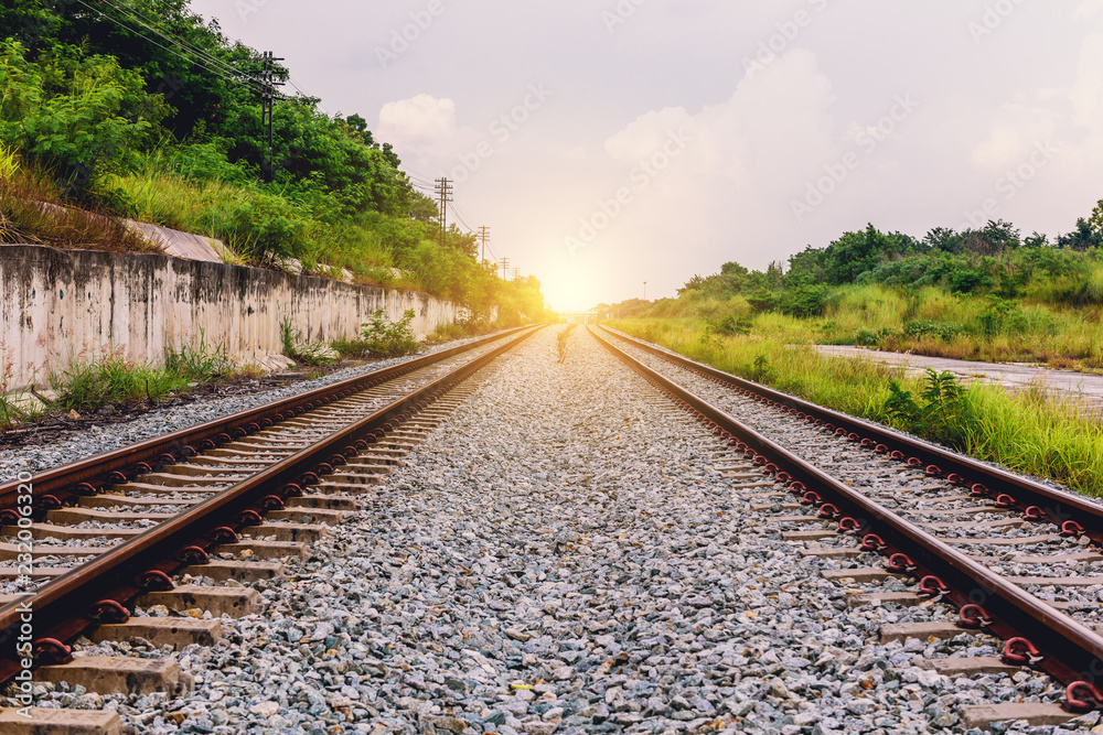 Fototapeta premium Railroad tracks in the setting sun