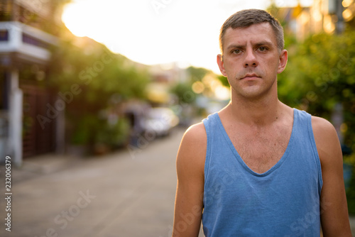 Handsome man with short hair relaxing in the streets outdoors