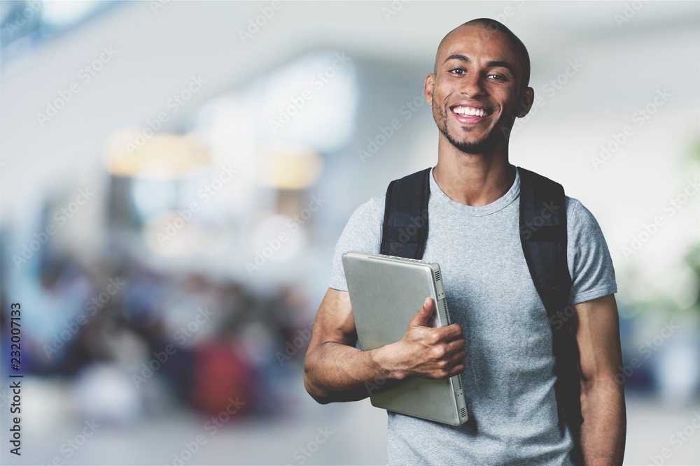 Wunschmotiv: Smiling African Student man with laptop #232007133