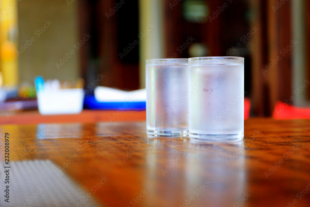 glass of water on wooden table in the morning glass of water on wooden table in the morning