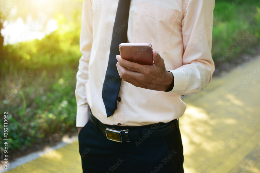Businessman holding smart phone and using  internet online