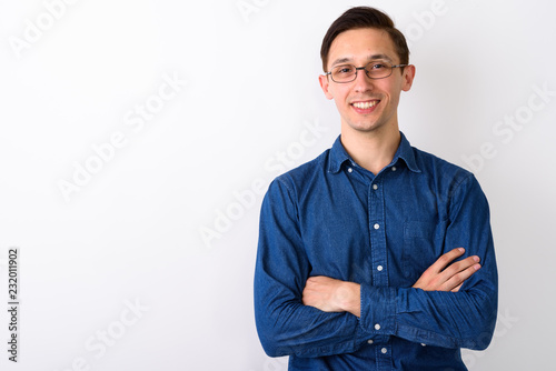 Quadro su tela Studio shot of young happy man smiling while wearing eyeglasses