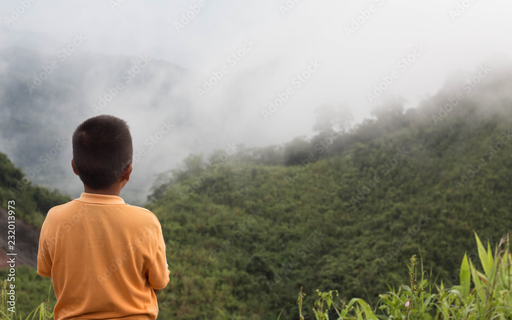 Boys are watching in nature with the mountains view. Boys are watching in nature with the mountains view.