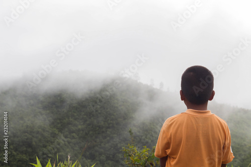Boys are watching in nature with the mountains view. © apassara