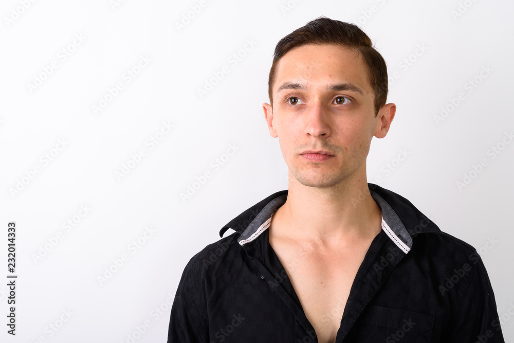 Close up of young handsome man thinking while looking at distanc Close up of young handsome man thinking while looking at distanc