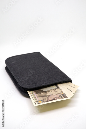 Japanese 10,000 Yens Banknote in Passport Holder on White Background
