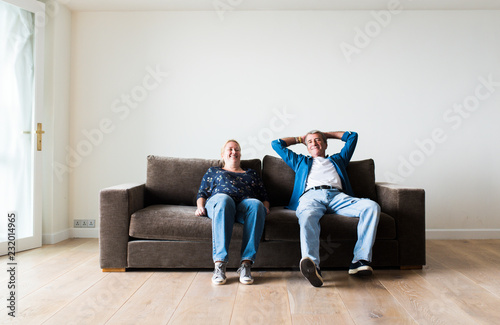 Couple sitting on a brown couch