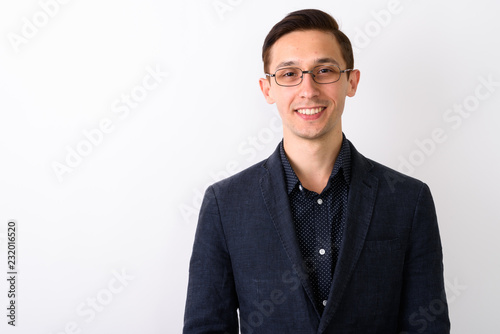 Close up of young happy businessman smiling while wearing eyegla © Ranta Images