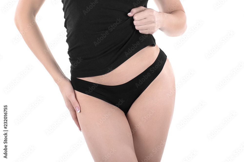 Female cropped fit back and buttocks in black panties and top, isolated on white. Female cropped fit back and buttocks in black panties and top, isolated on white.