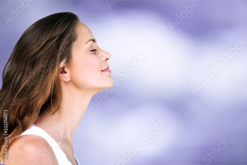 Young smiling woman on blurred natural background