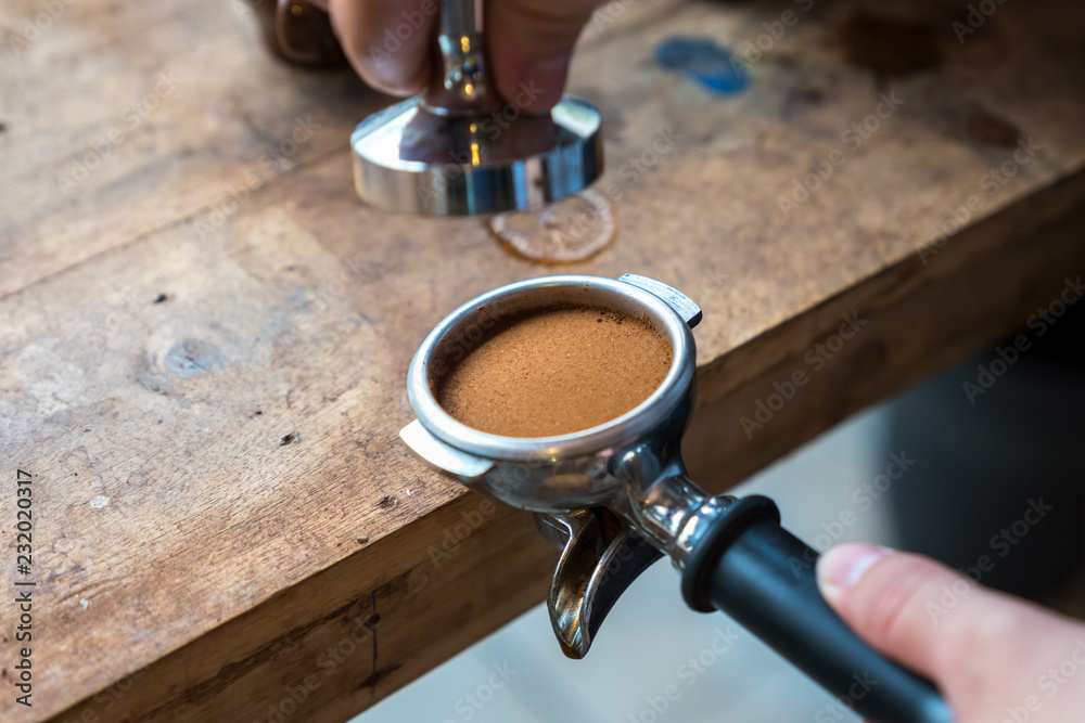 Ταπετσαρία Barista holding portafilter and coffee tamper making an espresso coffee