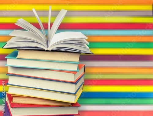Stack of books on colorful background
