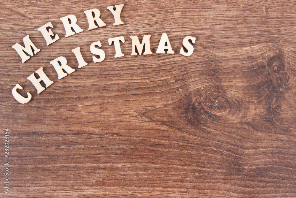 Inscription Merry Christmas on rustic board, festive time concept, place for inscription