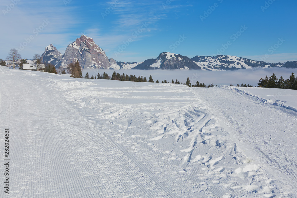 View from the village of Stoos in the Swiss canton of Schwyz in winter, Kleiner Mythen and Grosser Mythen summits in the background View from the village of Stoos in the Swiss canton of Schwyz in winter, Kleiner Mythen and Grosser Mythen summits in the background