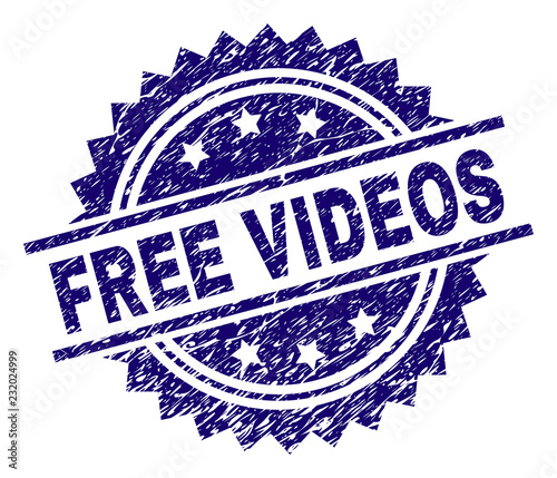 FREE VIDEOS stamp seal watermark with distress style. Blue vector rubber print of FREE VIDEOS caption with corroded texture.