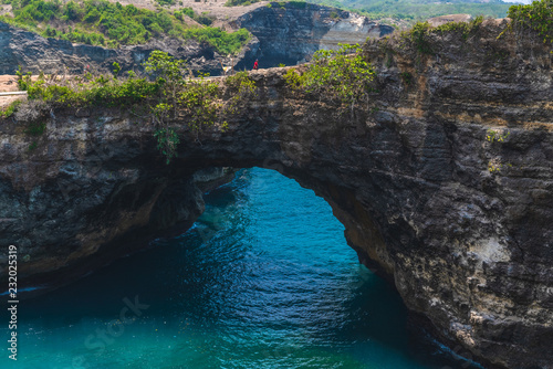 Rock coastline. Stone arch over the sea. Broken beach, Nusa Penida ,Indonesia. 