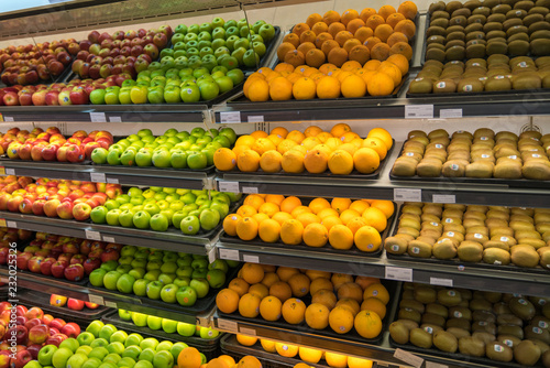 Fresh healthy fruits on shelves in supermarket