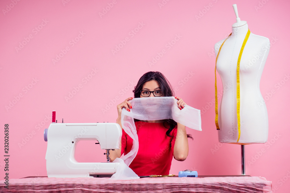 Premium Photo  Young dressmaker woman sews clothes on sewing machine